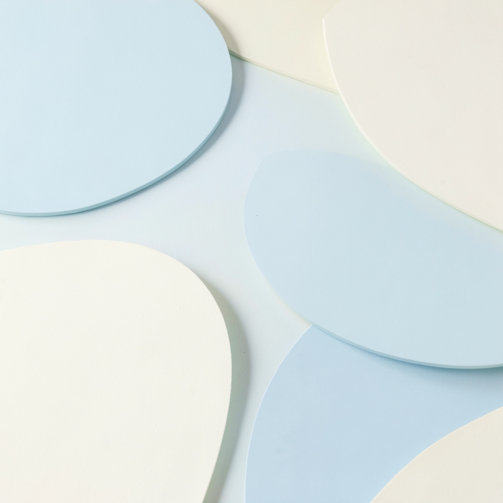 Soft pastel abstract shapes in pale blue and cream